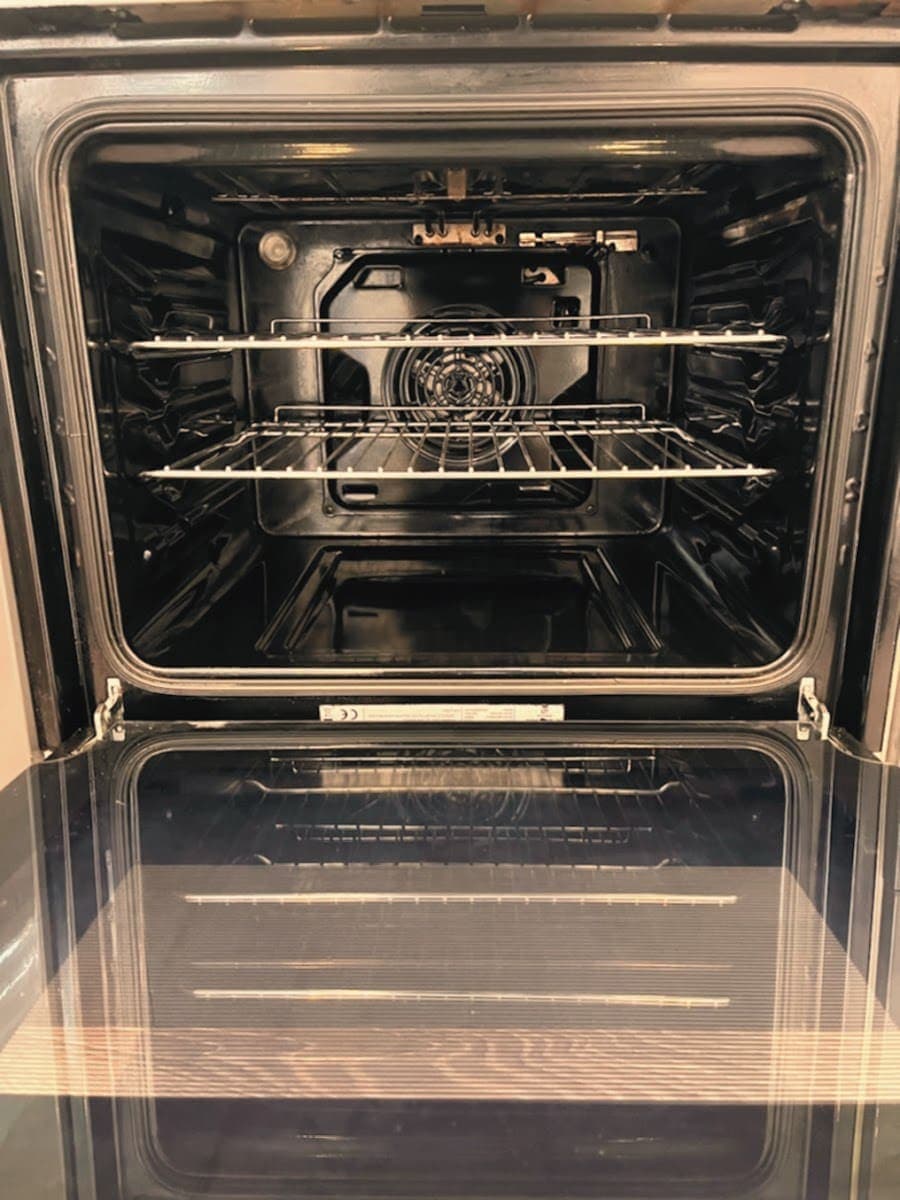 Oven cavity after cleaning with the fan cover and racks spotless