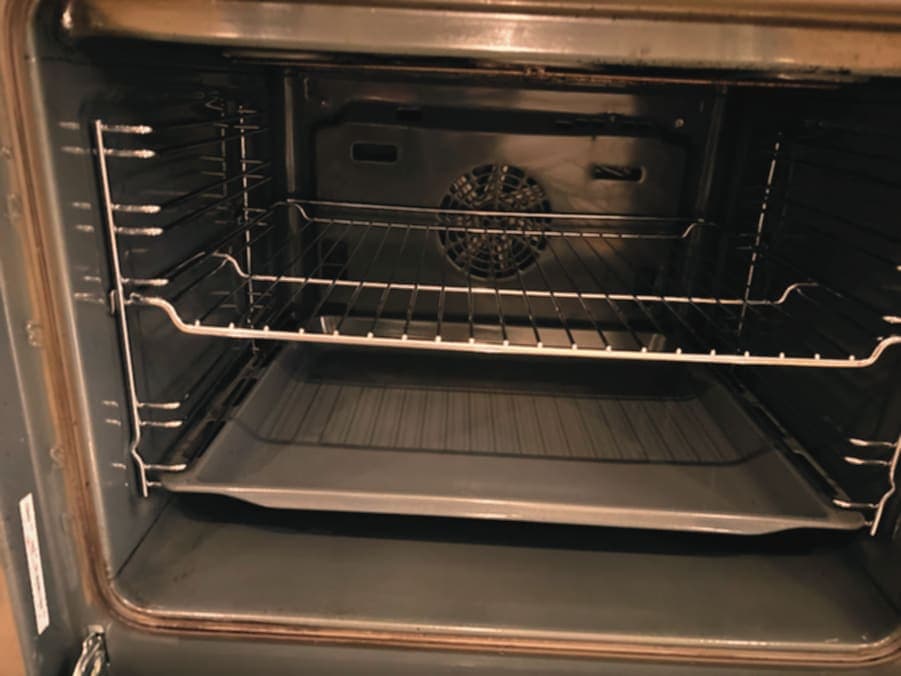 Grey enamel oven interior after cleaning with racks refitted
